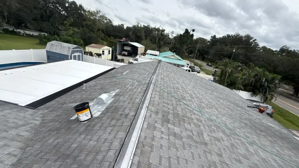 Roof repair crew inspecting shingles during a Seffner, FL job