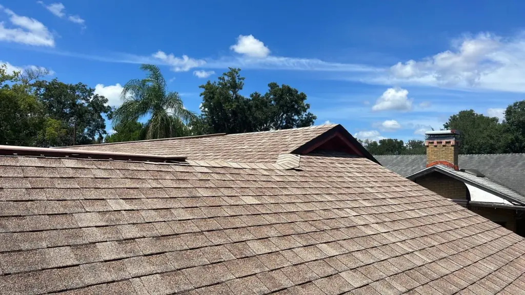 Crew member inspecting roof section during repair in Hillsborough County