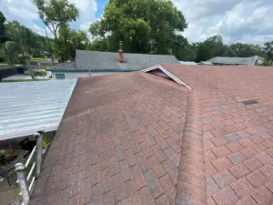 Crew inspecting surrounding roof area during a repair job in Hillsborough County