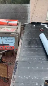 Crew setting new roofing material during a Hillsborough County roof replacement