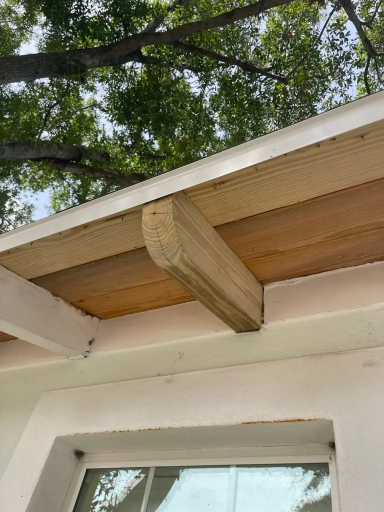 Roof replacement crew tearing off old shingles on a Hillsborough County home