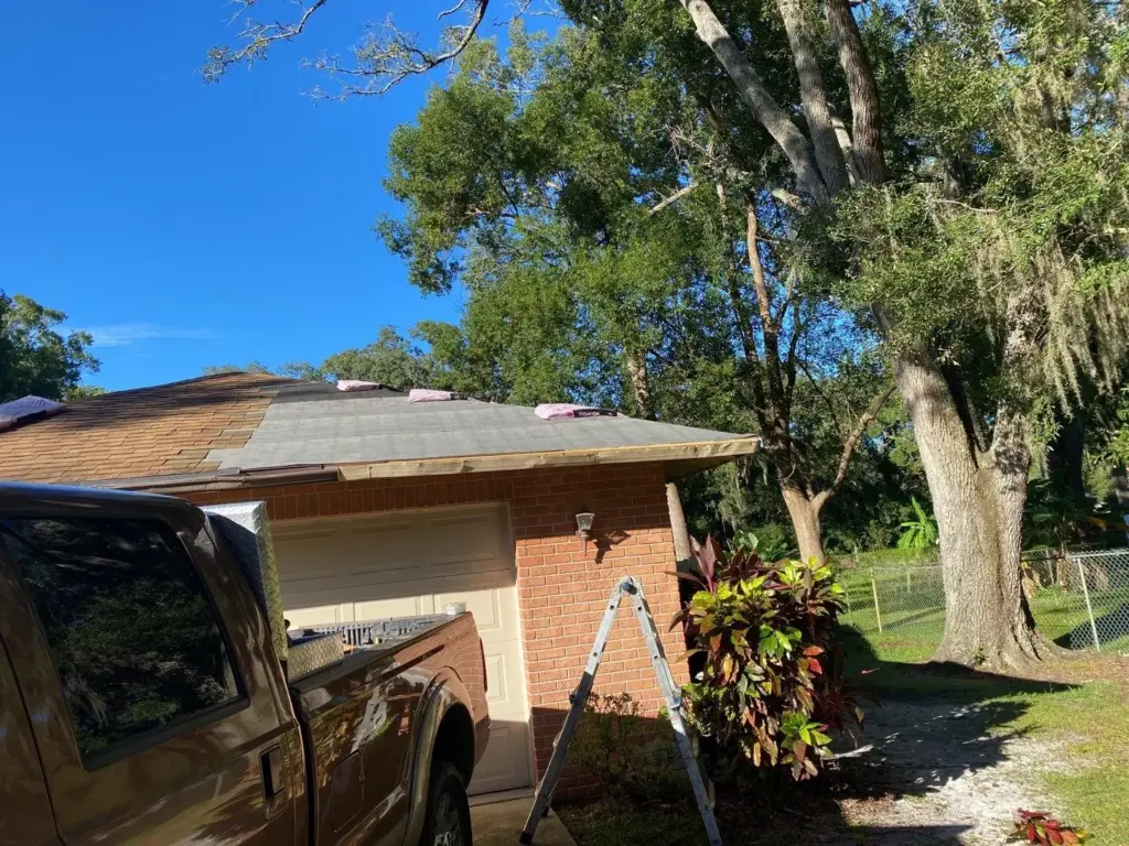 Crew tearing off old roofing during a roof replacement in Hillsborough County, FL