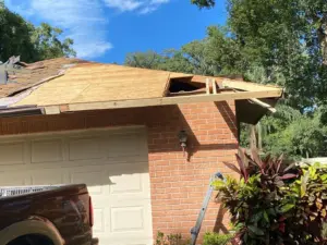 Roofing crew laying new shingles during a residential roof replacement in Hillsborough County
