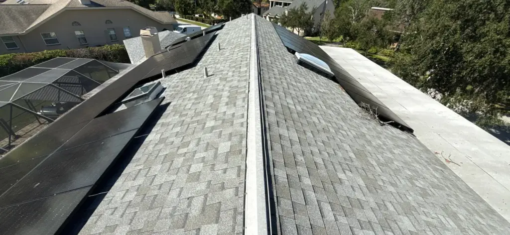 Crew removing old shingles during a roof replacement in Pinellas County