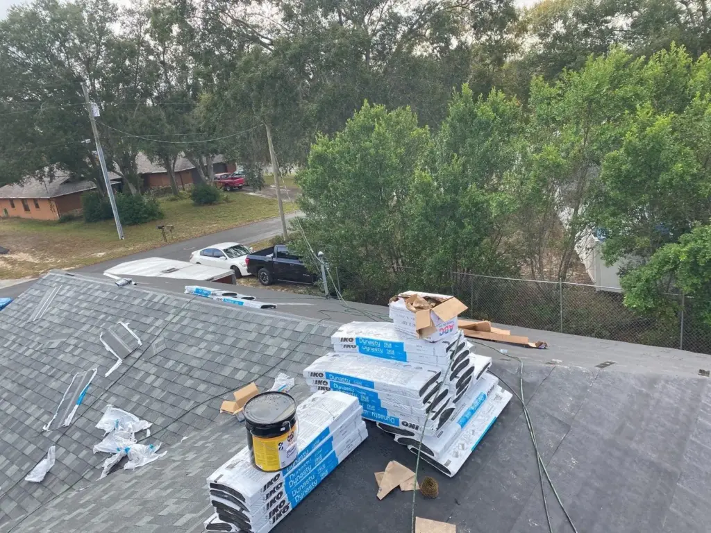 Crew removing old shingles during a roof replacement in the Tampa Bay area