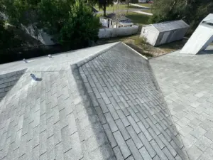 Crew setting shingles during a residential roof replacement in Tampa Bay