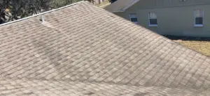 Crew setting new shingles as part of a roof replacement in Valrico, FL