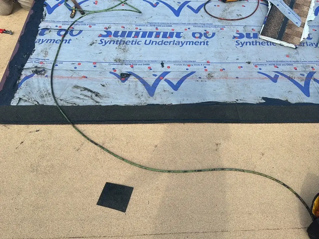 Crew tearing off old roofing during a roof replacement in Polk County