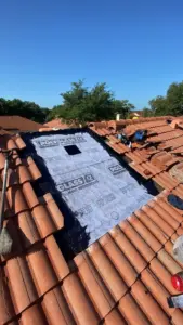 Roofing crew sealing a section during a Brandon repair job