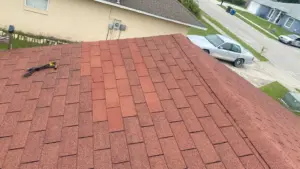 Crew tearing off old roofing during Polk County roof replacement
