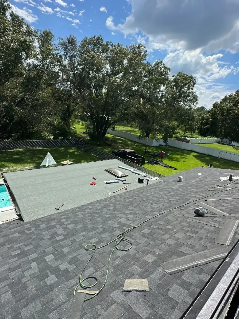 Crew tearing off old roofing during a roof replacement in Polk County, FL