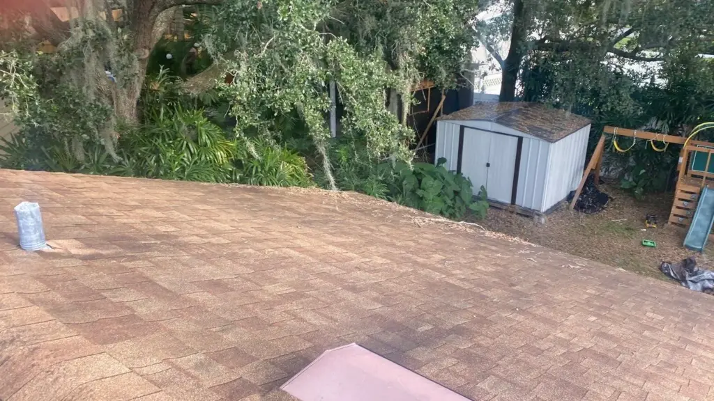 Crew tearing off old roofing during a roof replacement in Polk County