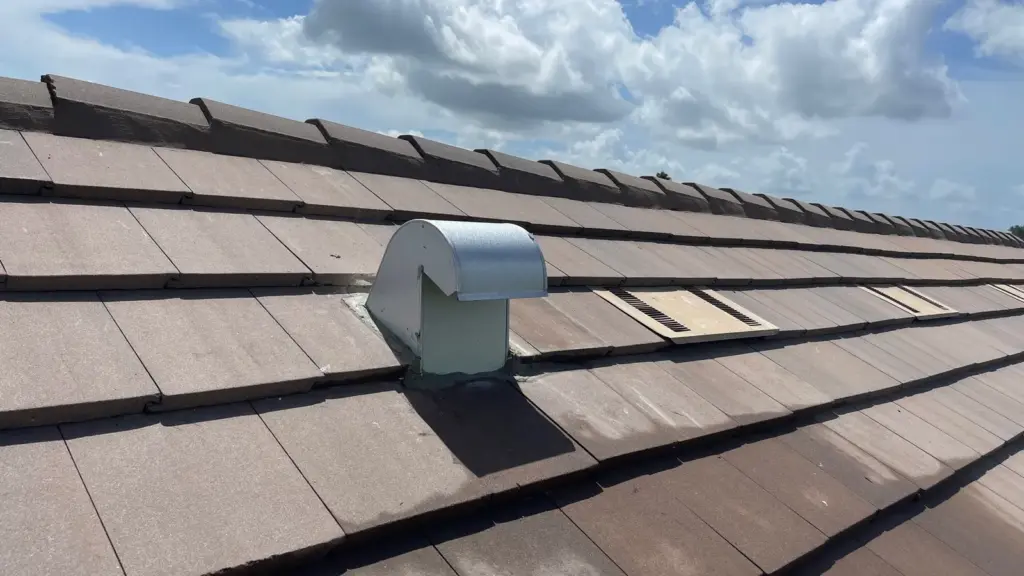 Roofer inspecting damaged section during roof repair in Hillsborough County