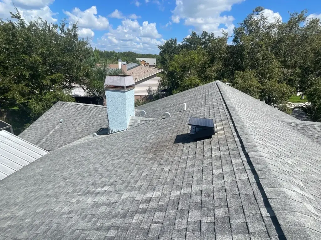 Finished roof replacement in Hillsborough County showing new shingles and ridge line.