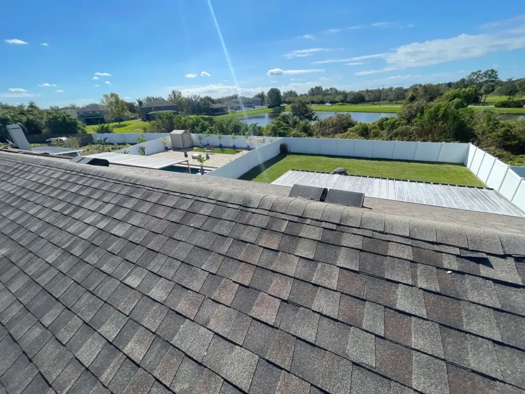 Roofer inspecting damaged section before starting roof repair in Riverview, FL
