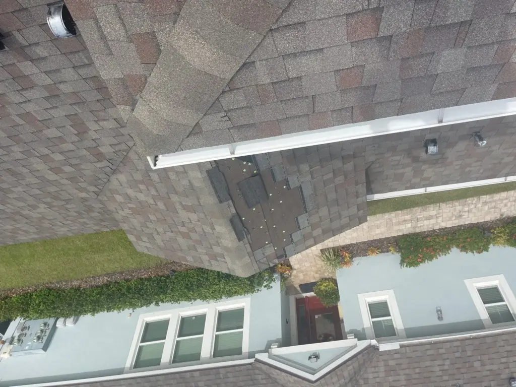 Tampa Bay roof replacement job showing torn-off decking before rebuild