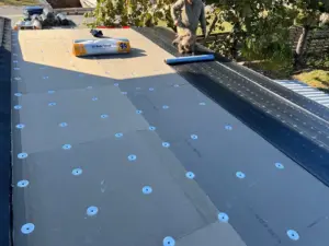 Crew working on deck inspection during roof replacement in Polk County