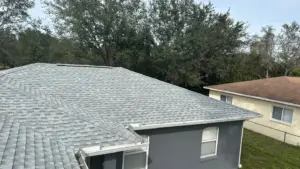 Roofing crew tearing off old shingles for replacement in Tampa Bay