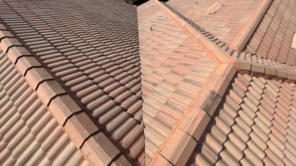 Crew member inspecting roof repair area on a Riverview home