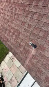 Crew member repairing a vent penetration on a Brandon home's roof