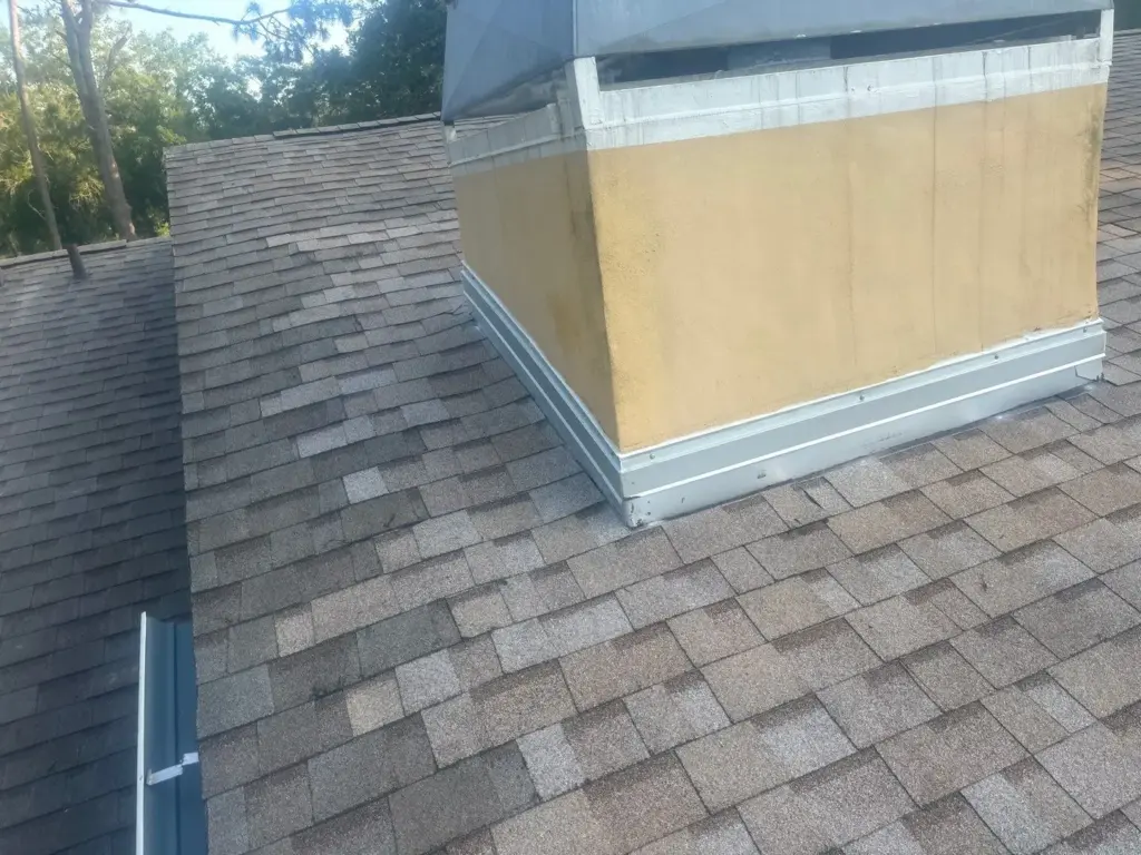 Crew member removing damaged roofing material during a repair in Wesley Chapel, FL