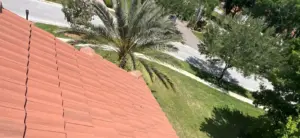 Crew member inspecting surrounding shingles after roof repair in Hillsborough County