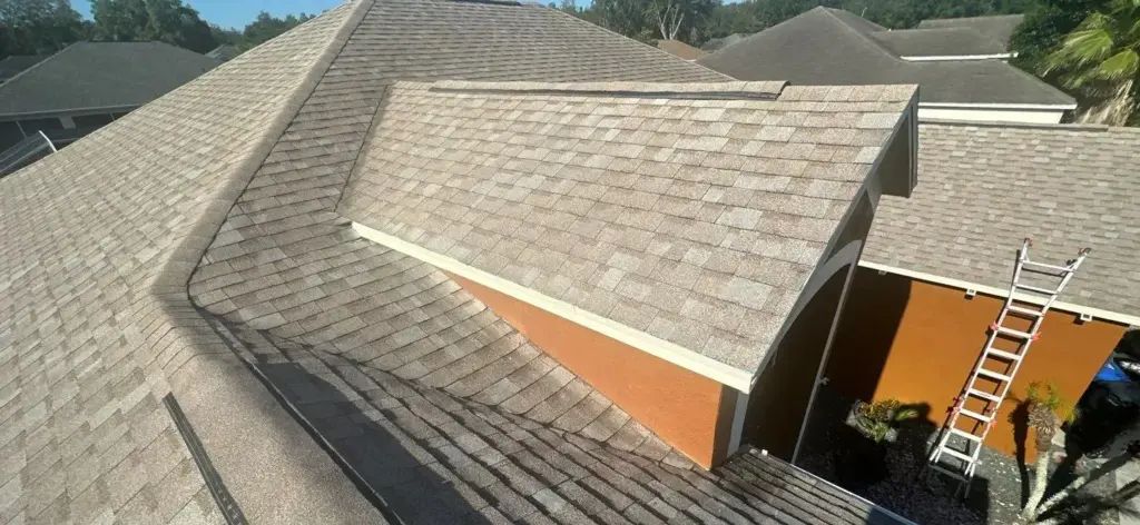 Roof repair crew assessing damage on a Valrico home