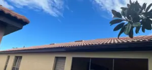 Removing damaged roofing material as part of a repair in Riverview