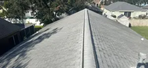 Shingles being matched to existing roof during repair work in Lutz