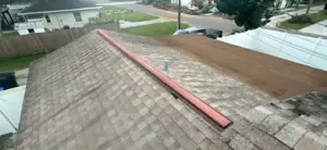 Crew member applying repair materials to a roof in St. Petersburg
