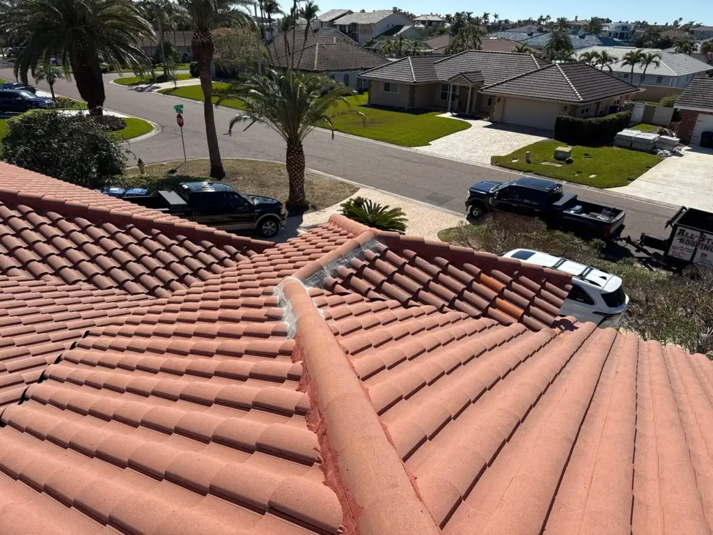 Roofer inspecting flashing during a roof repair in St. Petersburg, FL
