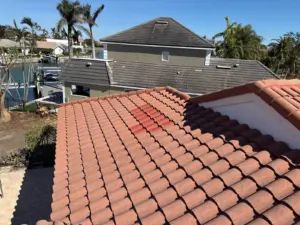 Crew member sealing a repaired section of roof in St. Petersburg, FL
