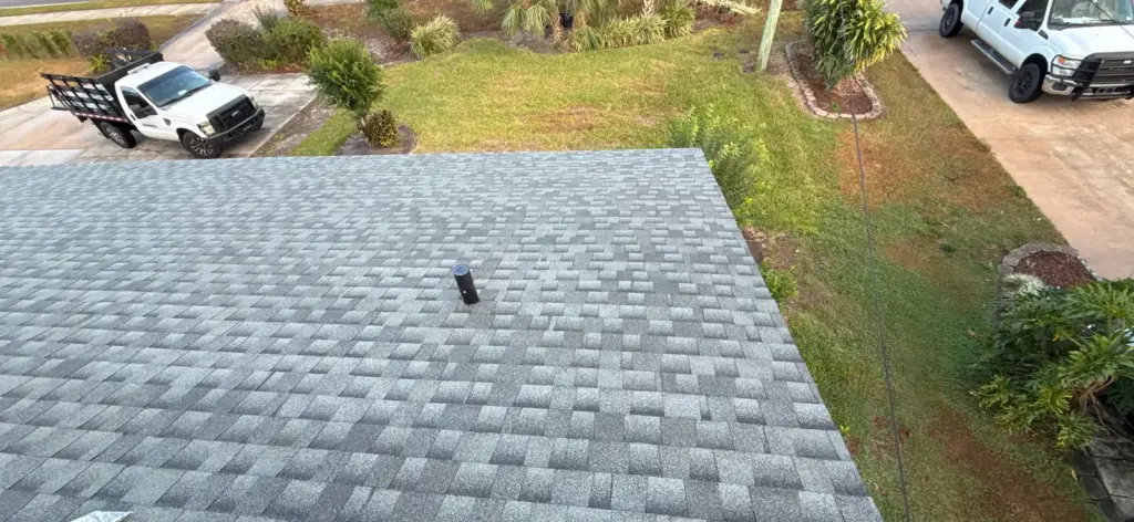 Roofer inspecting shingles during a roof repair job in Brandon, FL