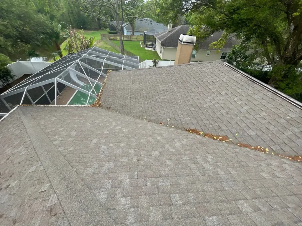 Roof repair in progress on a Lutz home showing exposed decking
