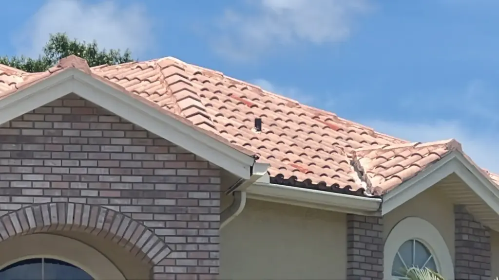 Crew member performing roof repair on a Hillsborough County home